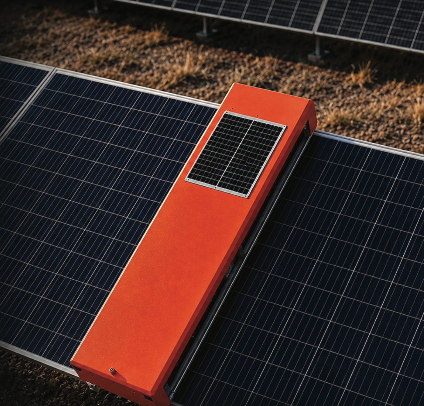 CBOT autonomous solar cleaning robot on a panel array — top-down view with integrated solar-powered brush unit