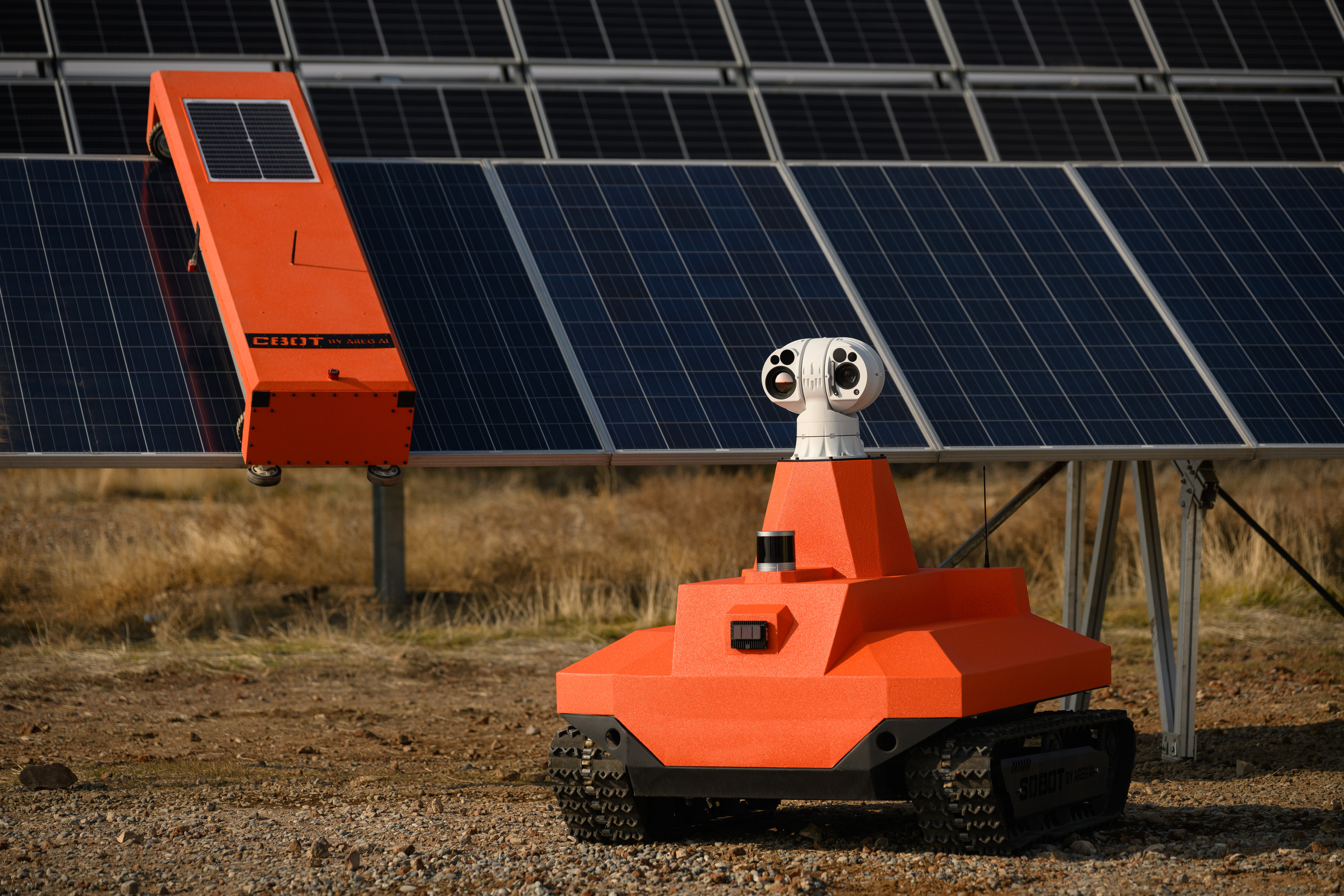 SOBOT inspecting a solar power plant — autonomous UGV alongside panel rows in the field with thermal and visual sensor head