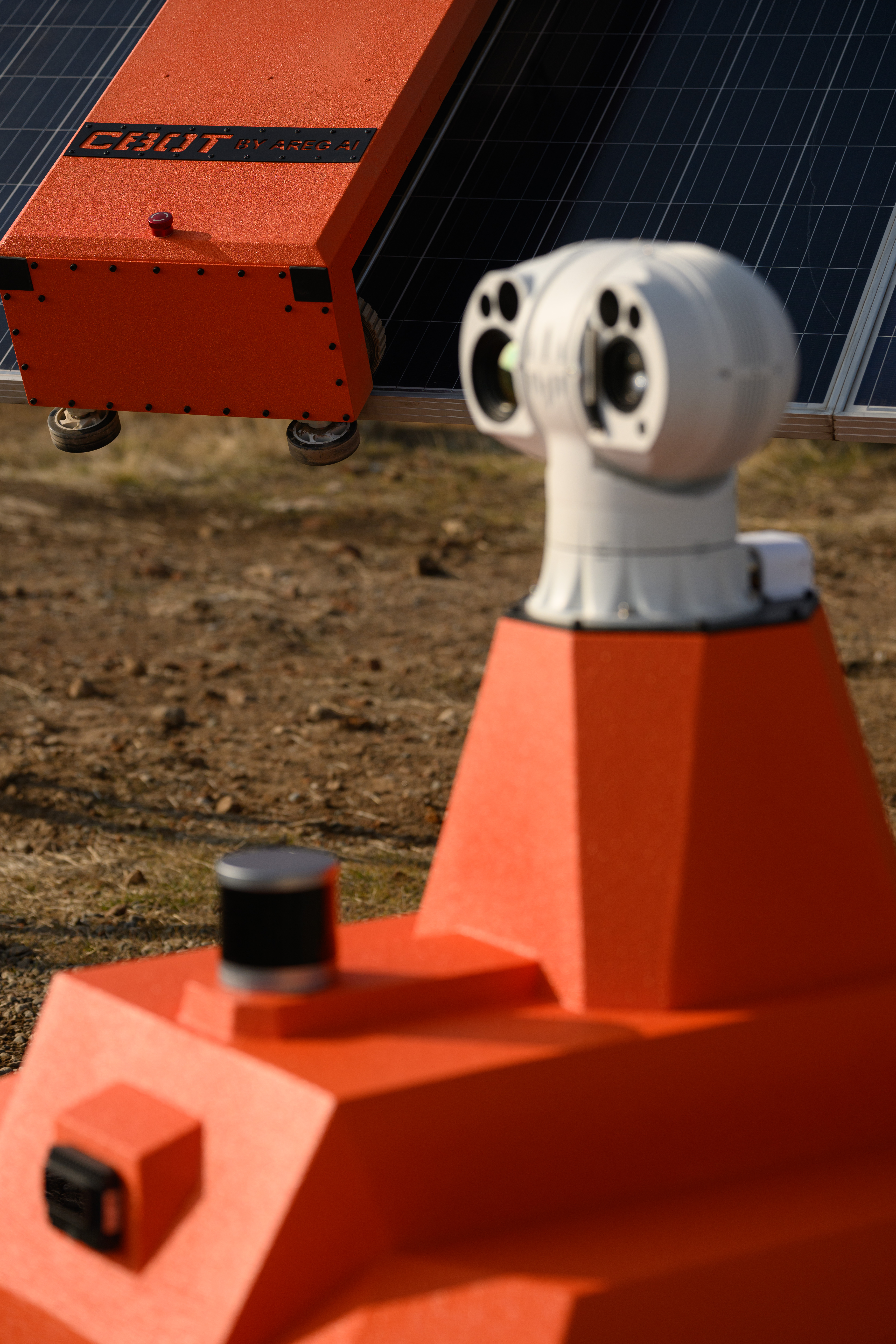 SOBOT dual thermal and visual sensor head — close detail in the field beside a solar panel